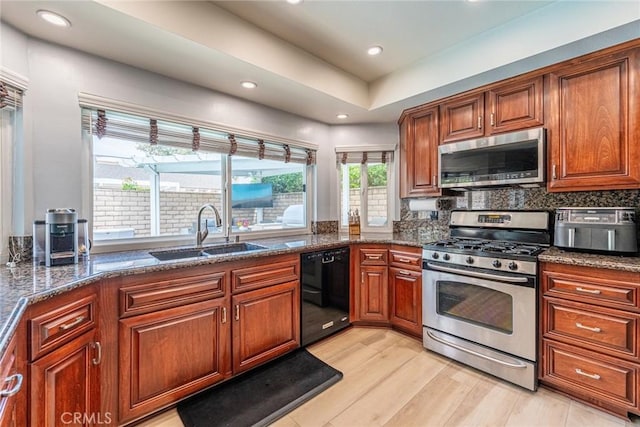5940 Avenida Antigua, Yorba Linda, CA 92887 - kitchen with appliances with stainless steel finishes, a sink, light wood-style flooring, dark stone counters, and recessed lighting