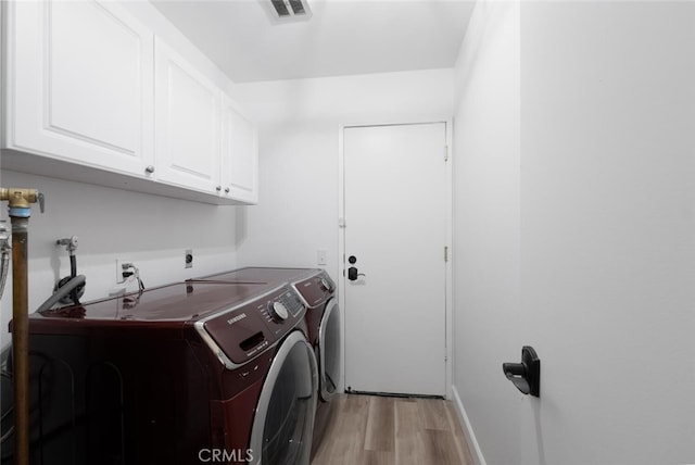 5453 Softwind Way, Agoura Hills, CA 91301 - laundry area with cabinet space, separate washer and dryer, light wood-type flooring, and baseboards
