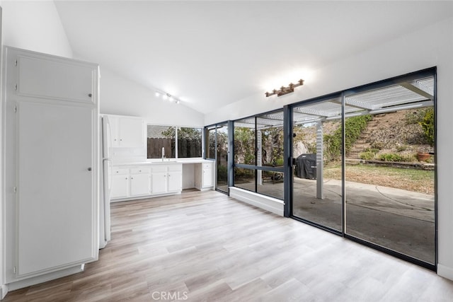 5453 Softwind Way, Agoura Hills, CA 91301 - unfurnished room featuring light wood finished floors, a sink, and high vaulted ceiling