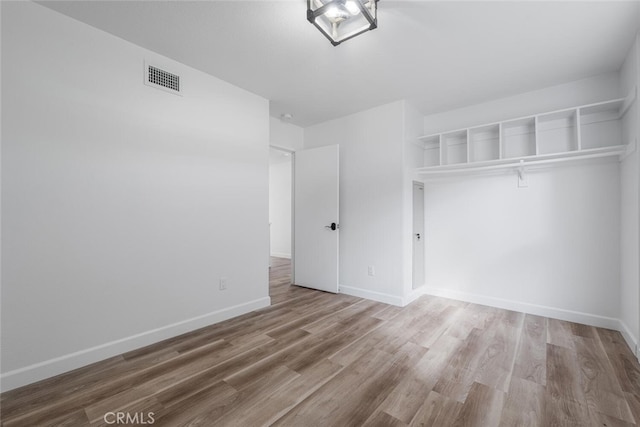 5453 Softwind Way, Agoura Hills, CA 91301 - unfurnished bedroom with wood finished floors and baseboards