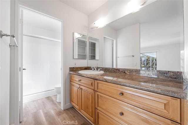 5453 Softwind Way, Agoura Hills, CA 91301 - bathroom with vanity, toilet, wood finished floors, and a shower