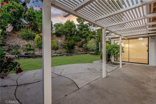 5453 Softwind Way, Agoura Hills, CA 91301 - patio terrace at dusk featuring a pergola, a lawn, and a patio