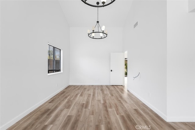 5453 Softwind Way, Agoura Hills, CA 91301 - spare room featuring high vaulted ceiling, a chandelier, healthy amount of natural light, and light wood-style flooring