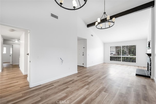 5453 Softwind Way, Agoura Hills, CA 91301 - unfurnished living room featuring a chandelier, high vaulted ceiling, beam ceiling, baseboards, and light wood-style floors