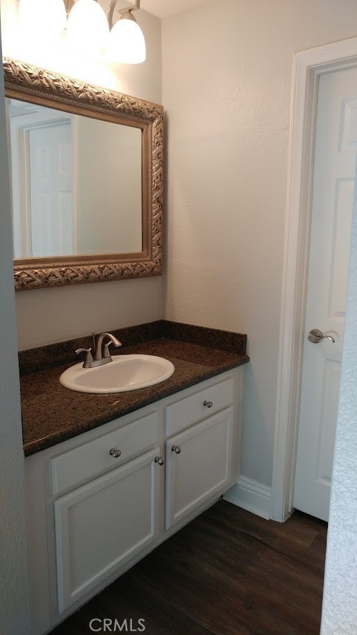 2400 Del Mar Way Unit 206, Corona, CA 92882 - bathroom featuring vanity and wood finished floors