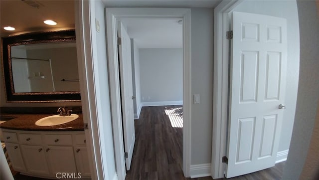 2400 Del Mar Way Unit 206, Corona, CA 92882 - hallway featuring a sink, baseboards, dark wood finished floors, and recessed lighting
