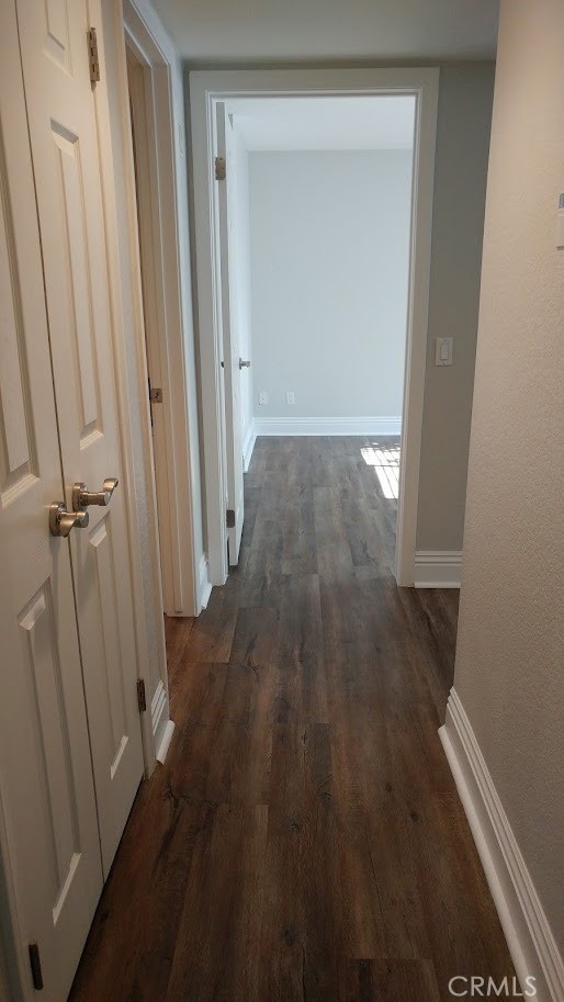 2400 Del Mar Way Unit 206, Corona, CA 92882 - hallway featuring dark wood-type flooring and baseboards