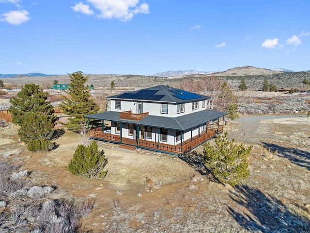 604 River Ranch Rd, Markleeville, CA 96120 - back of property featuring a porch, roof mounted solar panels, a mountain view, and a shingled roof