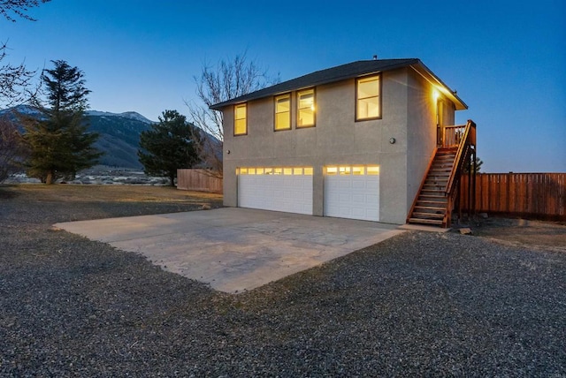 604 River Ranch Rd, Markleeville, CA 96120 - view of property exterior featuring stairway, stucco siding, a mountain view, and an attached garage