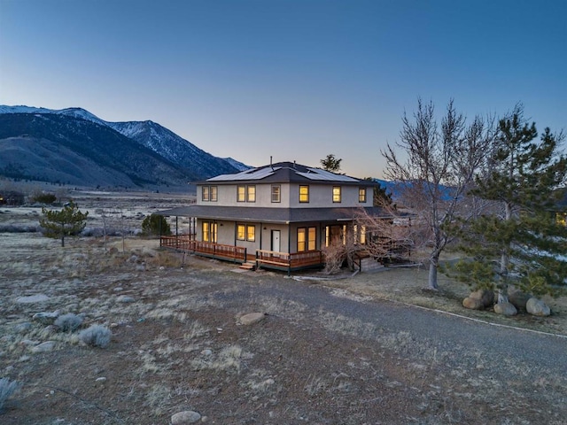 604 River Ranch Rd, Markleeville, CA 96120 - rear view of property featuring covered porch, roof mounted solar panels, and a mountain view