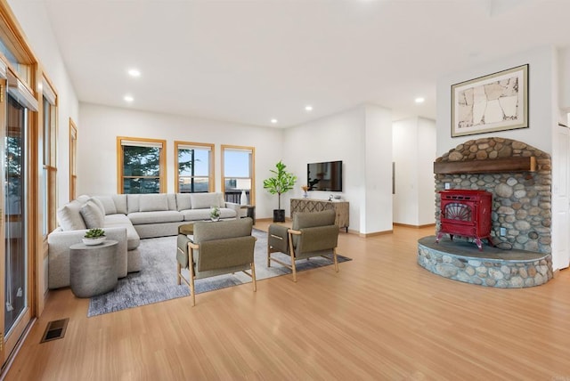 604 River Ranch Rd, Markleeville, CA 96120 - living room featuring light wood-style floors, a wood stove, recessed lighting, and baseboards