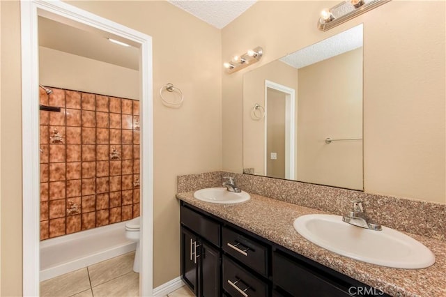 14317 Jicarilla Rd, Apple Valley, CA 92307 - full bathroom with toilet, double vanity, a shower, tile patterned flooring, and a textured ceiling