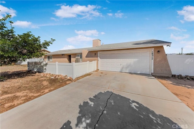 14317 Jicarilla Rd, Apple Valley, CA 92307 - single story home featuring stucco siding, driveway, a garage, and a chimney
