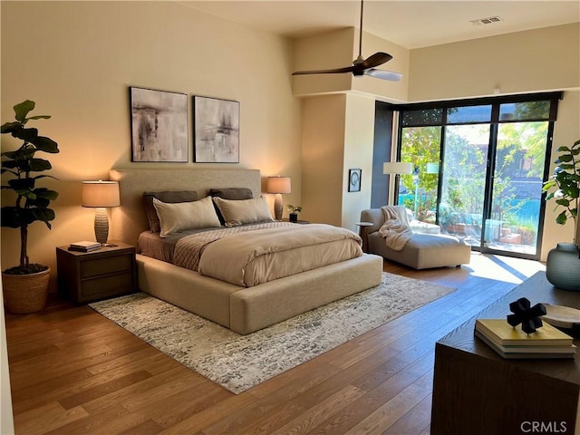 50135 Camino Privado Ln, Quinta, CA 92253 - bedroom with hardwood / wood-style floors, access to exterior, ceiling fan, and a towering ceiling