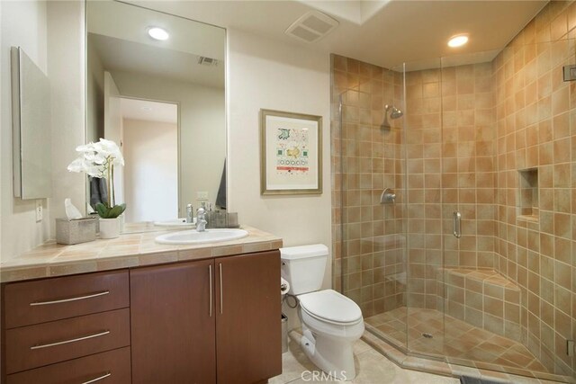 50135 Camino Privado Ln, Quinta, CA 92253 - bathroom featuring toilet, vanity, a stall shower, recessed lighting, and tile patterned flooring