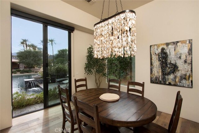 50135 Camino Privado Ln, Quinta, CA 92253 - dining area featuring wood finished floors and a chandelier