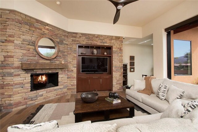 50135 Camino Privado Ln, Quinta, CA 92253 - living room featuring wood finished floors, a stone fireplace, and a ceiling fan