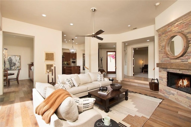 50135 Camino Privado Ln, Quinta, CA 92253 - living area featuring light wood-style floors, a ceiling fan, a stone fireplace, and recessed lighting