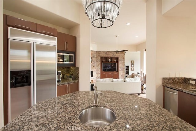 50135 Camino Privado Ln, Quinta, CA 92253 - kitchen featuring built in appliances, a sink, dark stone countertops, and recessed lighting