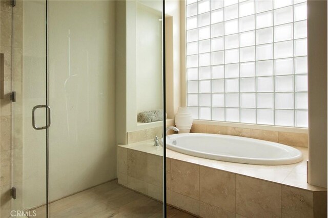 50135 Camino Privado Ln, Quinta, CA 92253 - bathroom with a garden tub, a shower stall, and wood finished floors