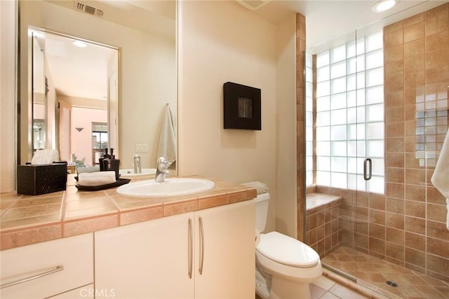50135 Camino Privado Ln, Quinta, CA 92253 - bathroom featuring toilet, a stall shower, vanity, tile patterned flooring, and recessed lighting