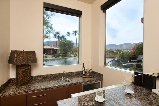 50135 Camino Privado Ln, Quinta, CA 92253 - kitchen with a sink, a mountain view, healthy amount of natural light, and dark stone countertops
