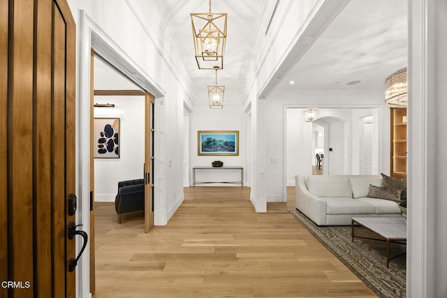 2060 Windover Rd, Pasadena, CA 91107 - foyer featuring arched walkways, crown molding, a chandelier, light wood finished floors, and baseboards