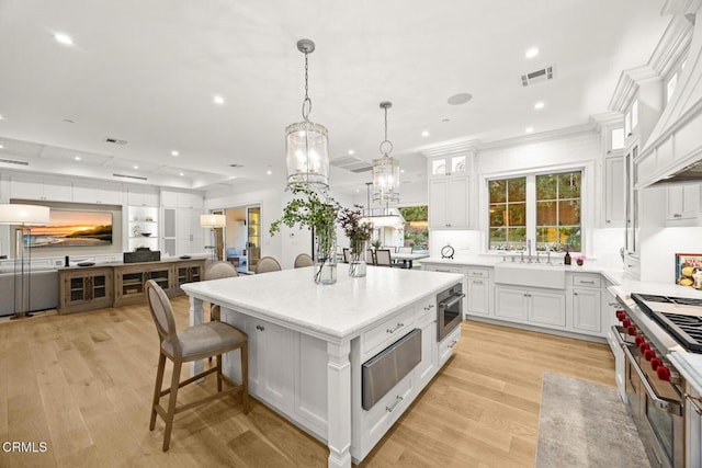 2060 Windover Rd, Pasadena, CA 91107 - kitchen featuring a sink, a kitchen island, white cabinetry, light countertops, and decorative backsplash