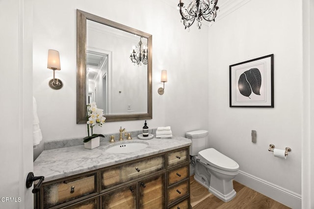 2060 Windover Rd, Pasadena, CA 91107 - half bath with vanity, toilet, wood finished floors, baseboards, and a chandelier