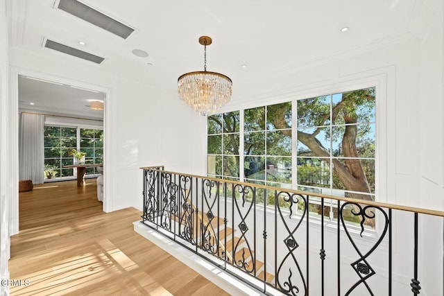 2060 Windover Rd, Pasadena, CA 91107 - hall with an upstairs landing, light wood-style floors, healthy amount of natural light, a chandelier, and a decorative wall