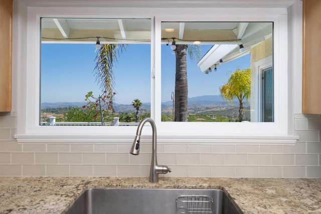 29730 Red Mountain Rd, Valley Center, CA 92082 - kitchen view of a sink, decorative backsplash, a mountain backdrop, and light stone countertops