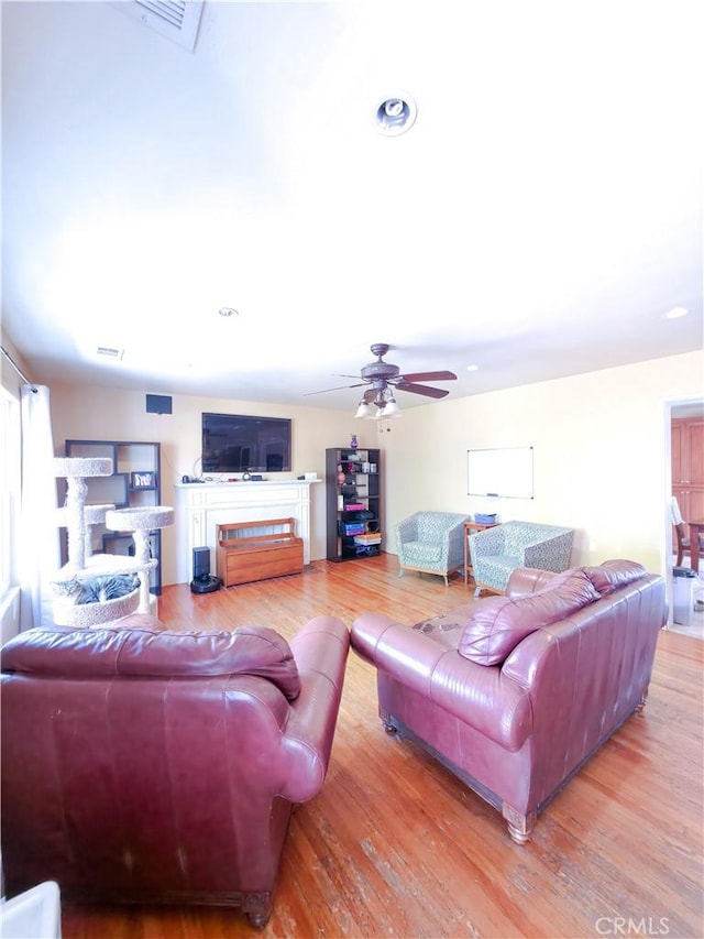3817 Somerset Dr, Los Angeles, CA 90008 - living room with wood finished floors, a ceiling fan, a fireplace, and recessed lighting