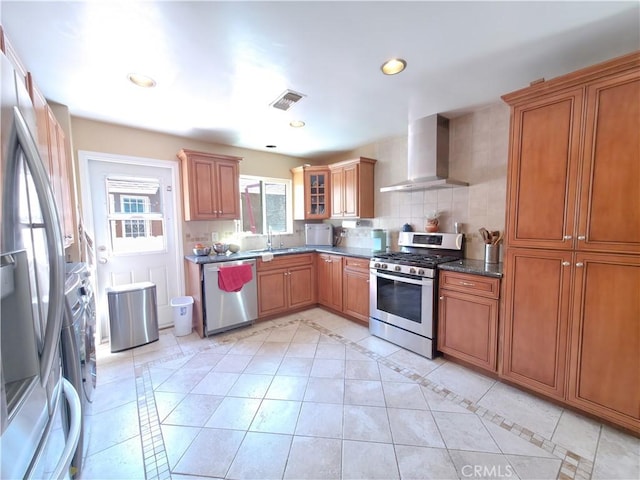 3817 Somerset Dr, Los Angeles, CA 90008 - kitchen with appliances with stainless steel finishes, wall chimney range hood, brown cabinets, a sink, and recessed lighting