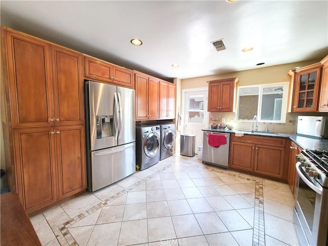 3817 Somerset Dr, Los Angeles, CA 90008 - kitchen with appliances with stainless steel finishes, washing machine and dryer, a sink, glass insert cabinets, and inlaid floor details