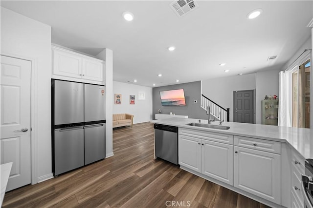 16007 Dexter St, Chino, CA 91708 - kitchen with appliances with stainless steel finishes, a sink, recessed lighting, white cabinetry, and dark wood-type flooring