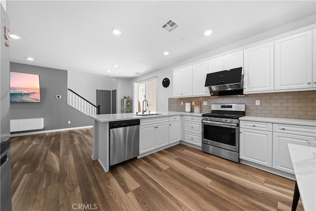 16007 Dexter St, Chino, CA 91708 - kitchen featuring stainless steel appliances, a sink, light countertops, a peninsula, and dark wood-style flooring