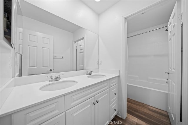 16007 Dexter St, Chino, CA 91708 - full bathroom with double vanity, wood finished floors, and bathing tub / shower combination