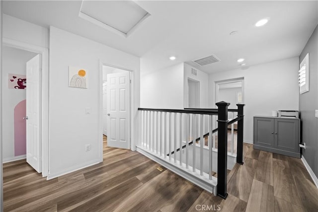 16007 Dexter St, Chino, CA 91708 - hallway with an upstairs landing, attic access, dark wood finished floors, baseboards, and recessed lighting