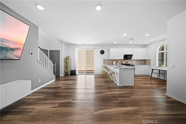 16007 Dexter St, Chino, CA 91708 - kitchen featuring stainless steel range, light countertops, white cabinets, dark wood-style floors, and recessed lighting