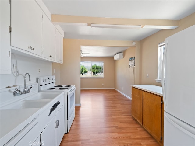 16183 18th Ave, Clearlake, CA 95422 - kitchen featuring white appliances, light countertops, light wood finished floors, an AC wall unit, and white cabinetry