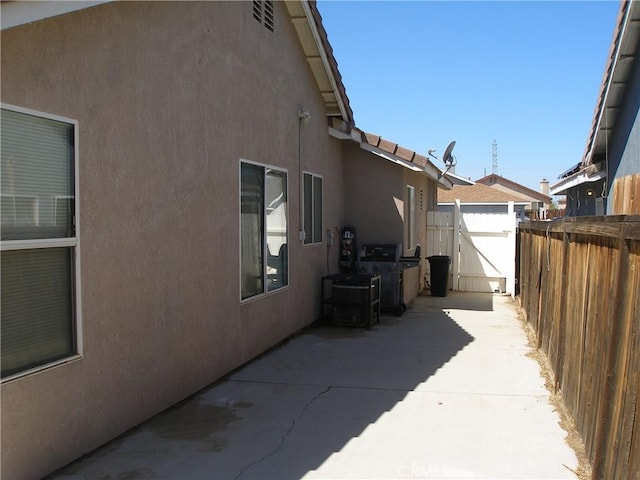 12975 Stanford Dr, Victorville, CA 92392 - view of property exterior with stucco siding and a patio area