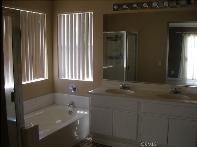 12975 Stanford Dr, Victorville, CA 92392 - full bath featuring double vanity, a garden tub, and a stall shower
