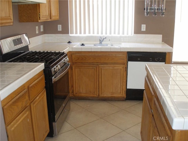 12975 Stanford Dr, Victorville, CA 92392 - kitchen with stainless steel gas range oven, white dishwasher, a sink, exhaust hood, and brown cabinets
