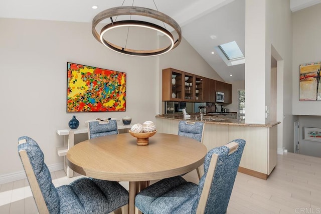 12812 Caminito En Flor, Del Mar, CA 92014 - dining space with a skylight, vaulted ceiling, light wood-style floors, recessed lighting, and baseboards