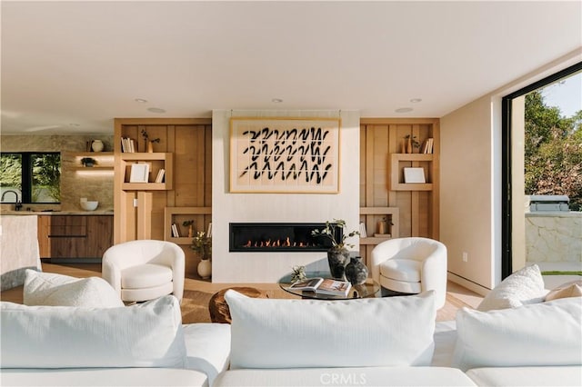 2608 Zorada Dr, Los Angeles, CA 90046 - living room with plenty of natural light, a glass covered fireplace, wood finished floors, and built in features