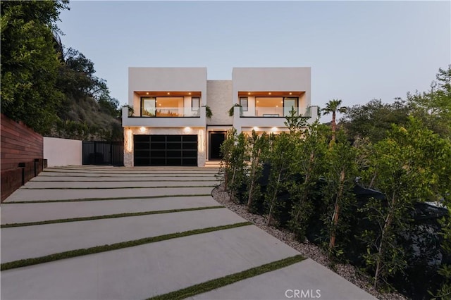 2608 Zorada Dr, Los Angeles, CA 90046 - contemporary house featuring a balcony, driveway, and stucco siding