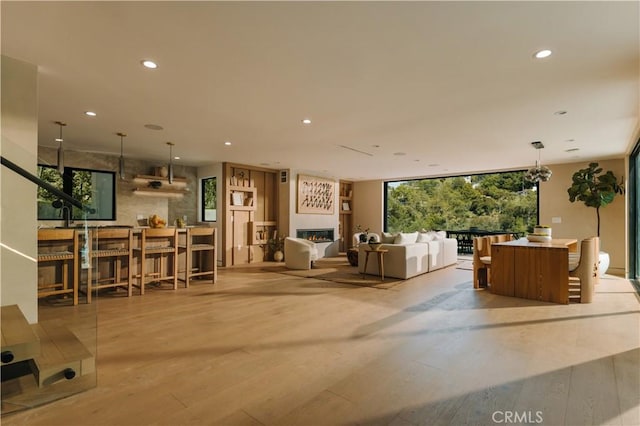2608 Zorada Dr, Los Angeles, CA 90046 - living area with wood finished floors, recessed lighting, and a lit fireplace