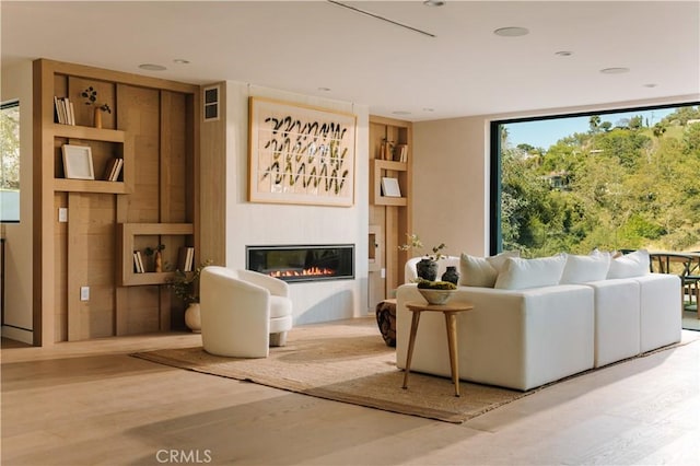 2608 Zorada Dr, Los Angeles, CA 90046 - living room with a glass covered fireplace, wood finished floors, and plenty of natural light