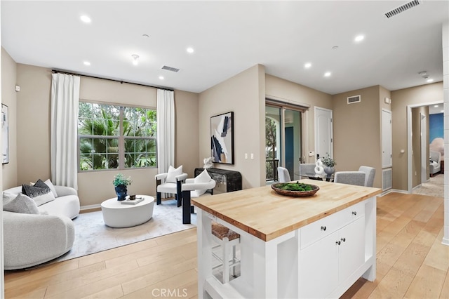 108 Coastal Gdn, Irvine, CA 92618 - kitchen with wood counters, light wood-type flooring, white cabinets, open floor plan, and recessed lighting