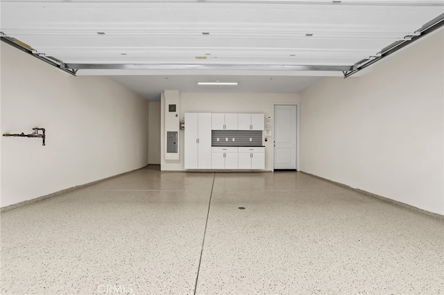 108 Coastal Gdn, Irvine, CA 92618 - garage with baseboards and electric panel